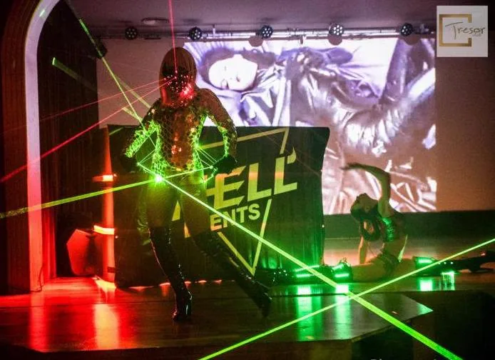 A green neon sign above the dance floor